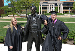 Photo of graduates posing with a statue of Abraham Lincoln. Links to Gifts That Protect Your Assets